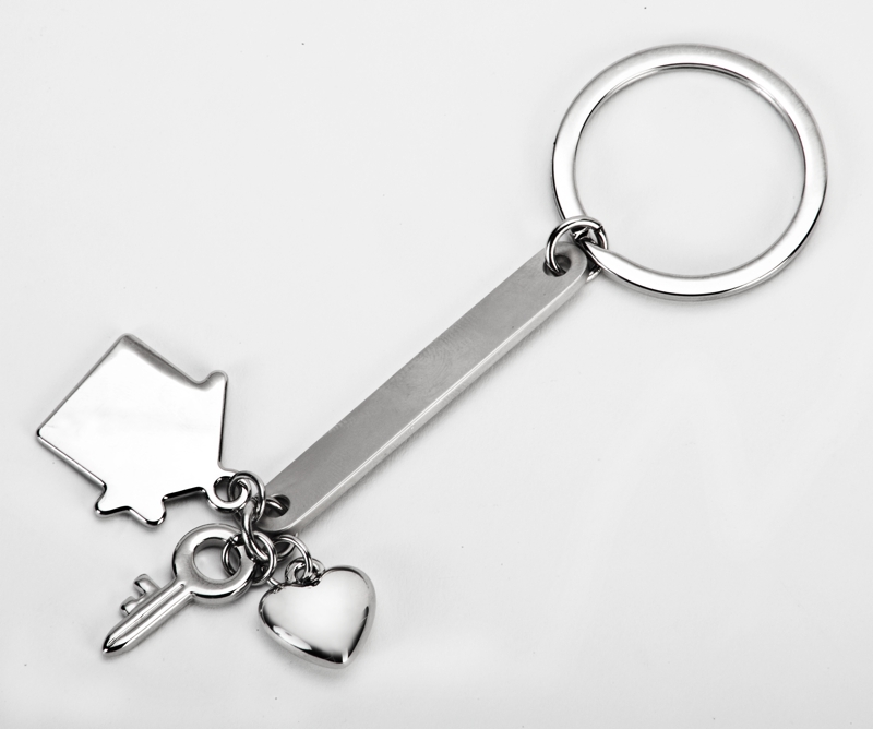 קשר - מחזיק מפתחות עם פס מתכת ותליוני מנעול, בית ולב.
